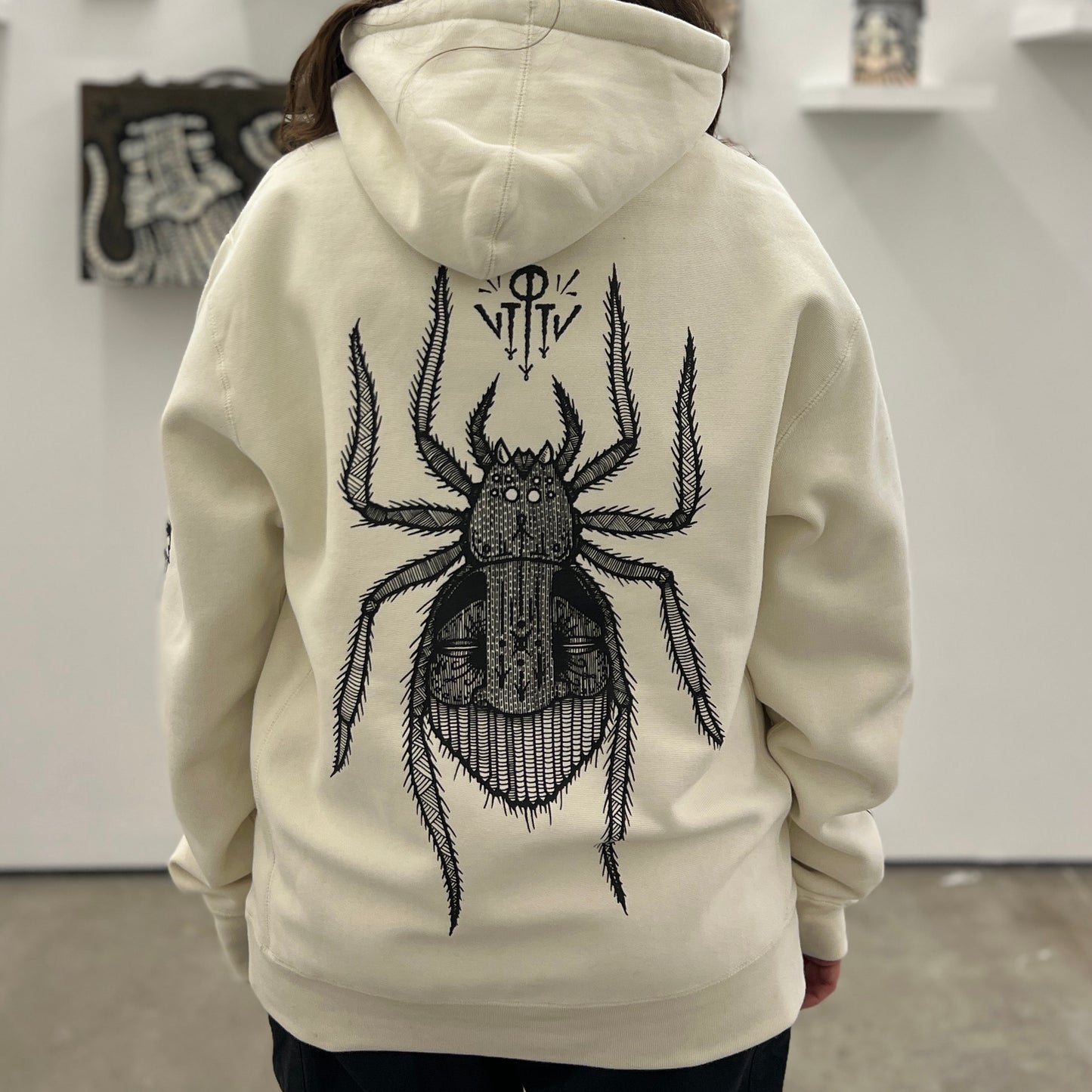  by GATS titled GATS - "Arachnophile" Hooded Sweatshirt in Bone