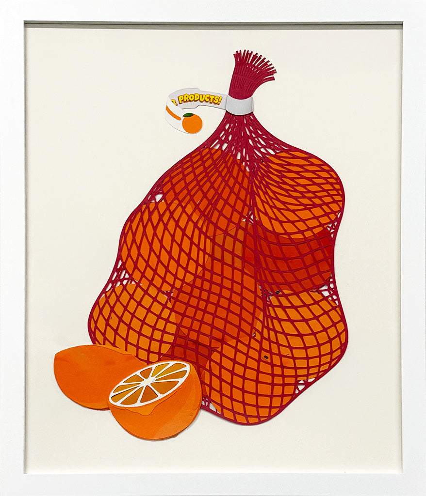 Framed painting of oranges in a red mesh bag with a cut orange in front of the bag