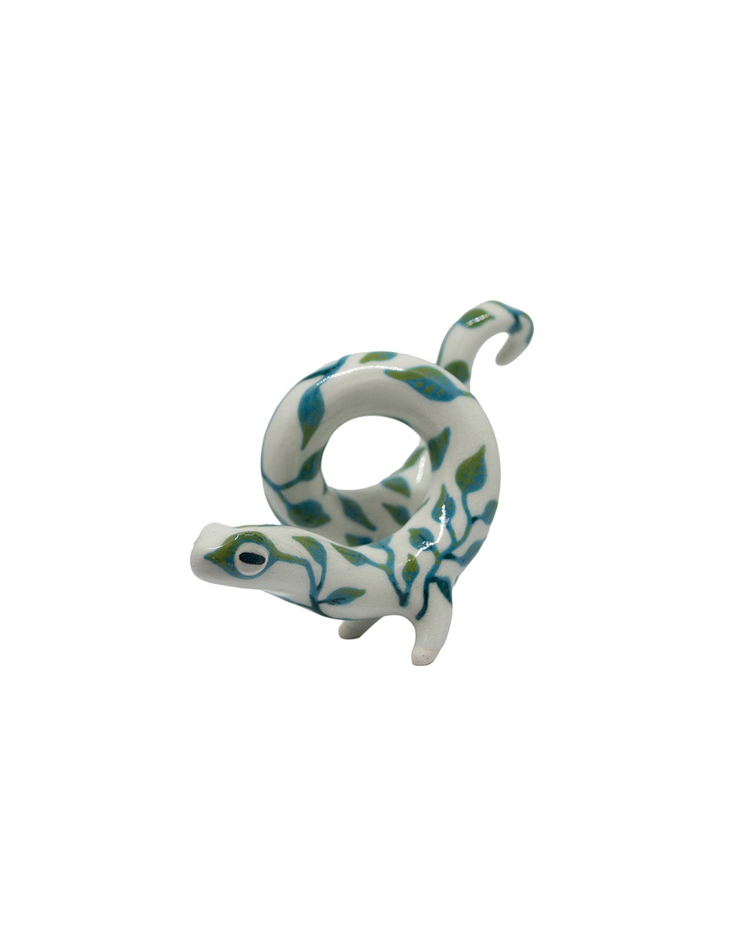 Decorative ceramic lizard with green leaf patterns on a white background