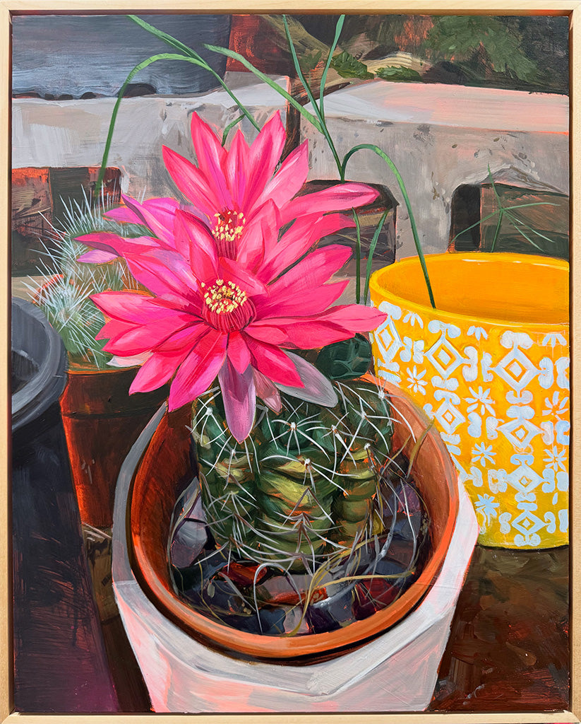 Painting of a cactus with a pink flower in a pot on a table.
