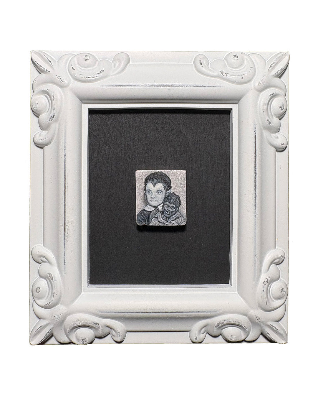 Decorative white frame with a small portrait on a black background