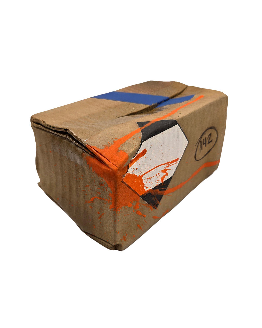 Cardboard looking ceramic box with orange and blue accents on a white background