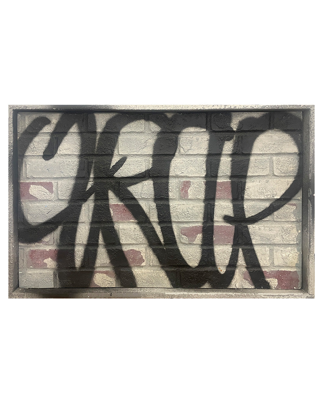 concrete wall art with 'Trap' text on a brick-patterned background