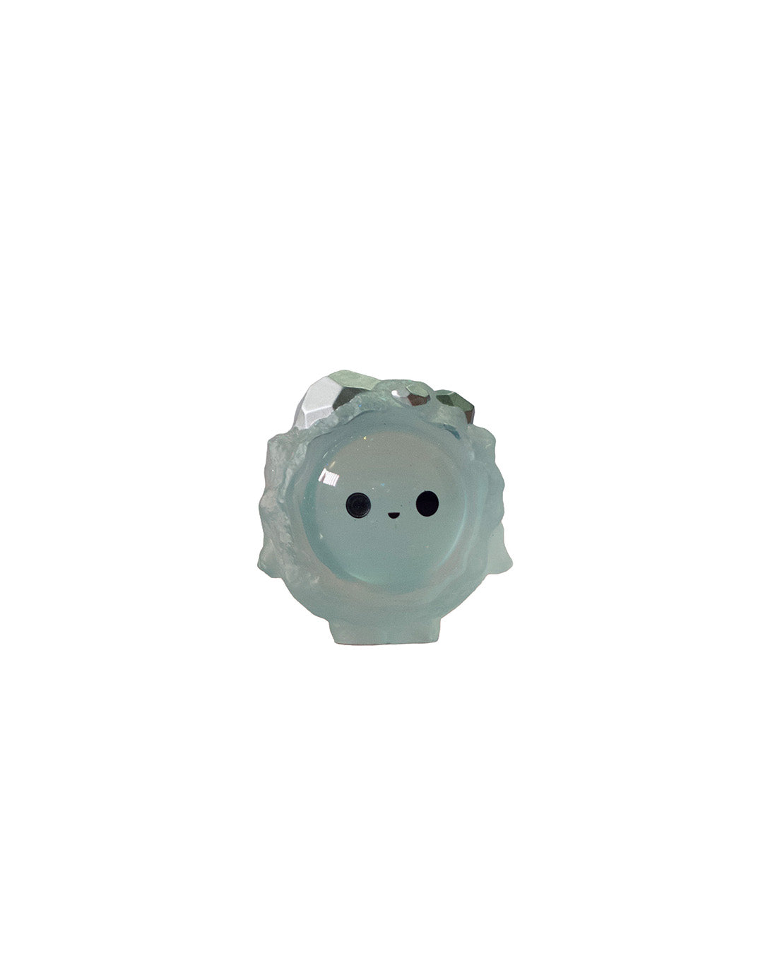 Sphere shaped figurine with a smiley face and crystals growing out of it